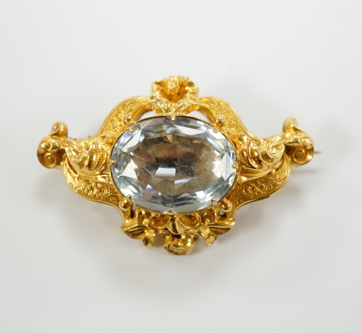 A Victorian yellow metal (tests as 15ct gold) and single stone oval cut aquamarine set brooch, 38mm, gross weight 7.1 grams.